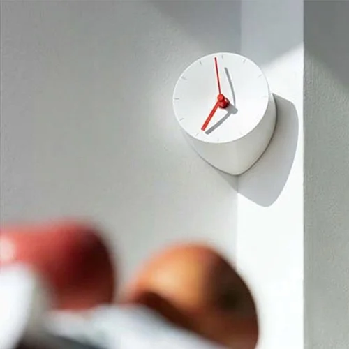 White Mosery clock by Park Sung-ho and Lee Seong-yong with contrasting red hands.