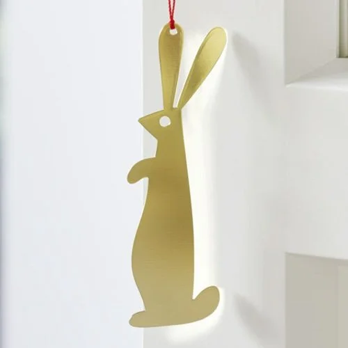 Designer brass ornament inspired by Girard’s 1965 folk-inspired graphic symbols.