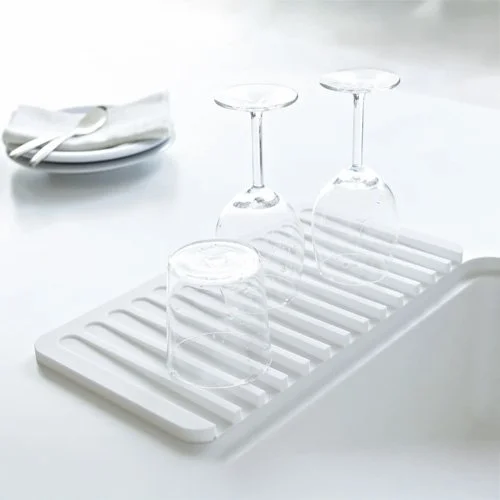 Modern dish tray with sloped design to drain water directly into the sink.