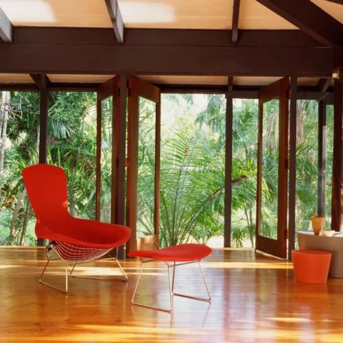Sculptural lounge chair with upholstered seat and powder-coated steel base.
