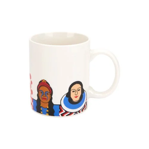 Stylish kitchen or studio scene with Andy Tuohy’s art mug beside brushes and sketchbooks.