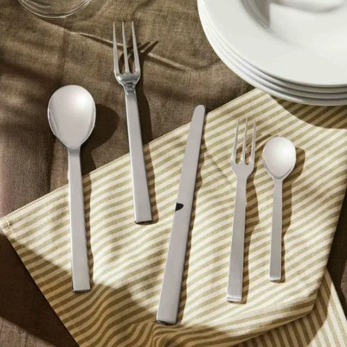 Five-piece Alessi flatware set blending minimalist design with Italian elegance.