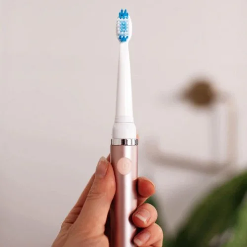 Lightweight battery-powered electric toothbrush designed for travel and home use