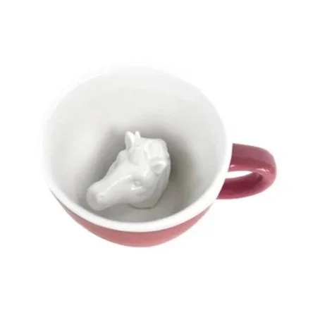 Bubblegum pink ceramic mug with hidden unicorn sculpture inside.