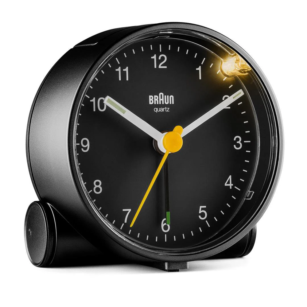 Modern black bedside clock featuring quiet quartz, luminous hands, and integrated snooze/light.