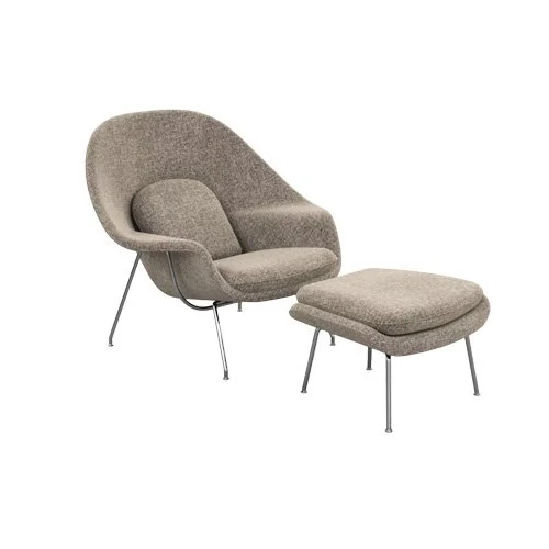 Iconic midcentury Womb Chair with ottoman, steel base, and full upholstery.