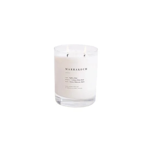 Hand-poured Marrakech candle with saffron, birch, and myrrh in a modern glass vessel.