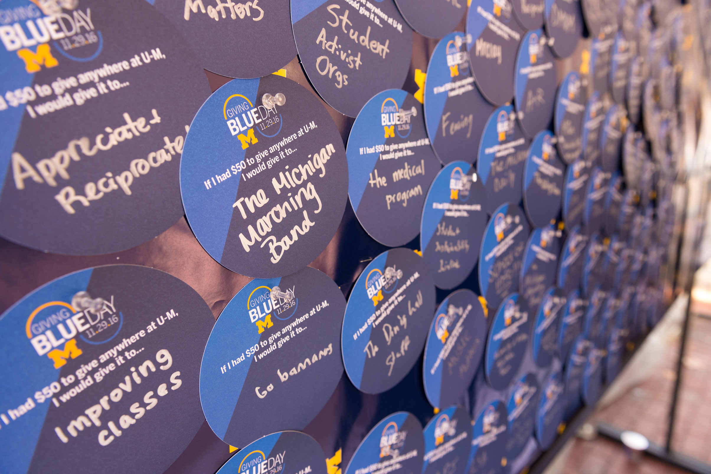 Banners and environmental signage displayed on campus leading up to Giving Blueday.