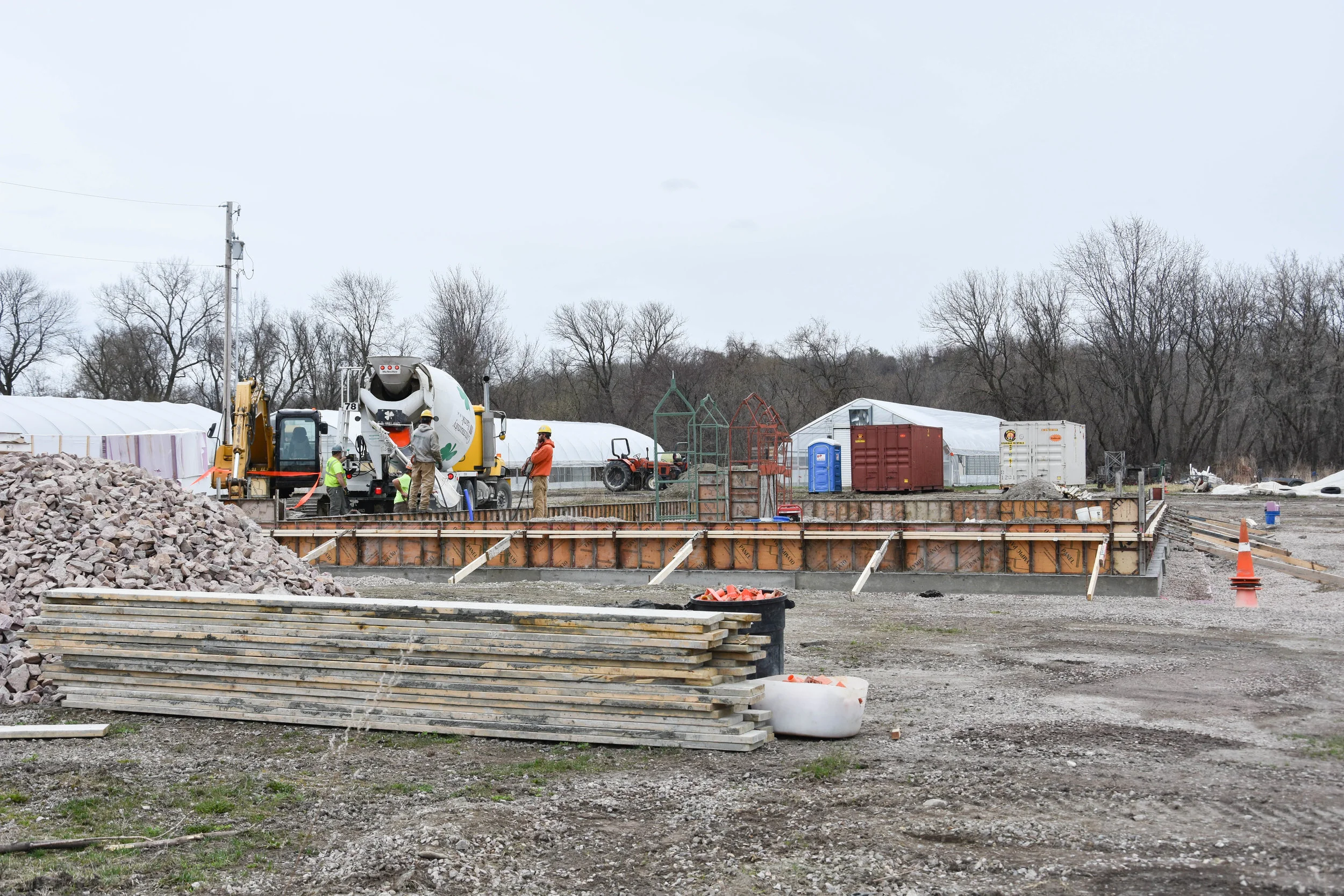 Pouring concrete for the pack shed foundation.