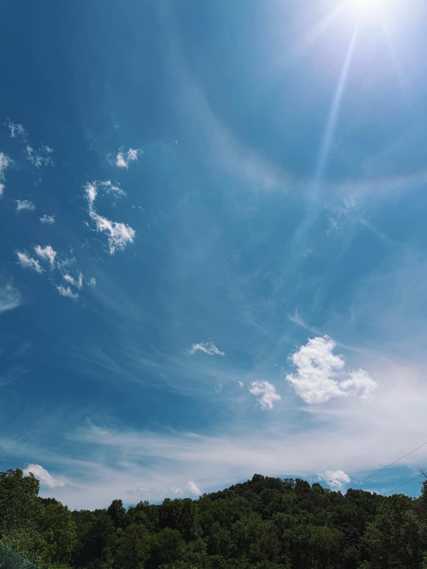 Brilliant blues in the sky and soil yesterday. 💙 And a solar halo! Have you ever seen one? 

A solar halo is a faint rainbow around the sun, caused by sunlight refracting through millions of hexagonal ice crystals in high-altitude cirrus clouds. The
