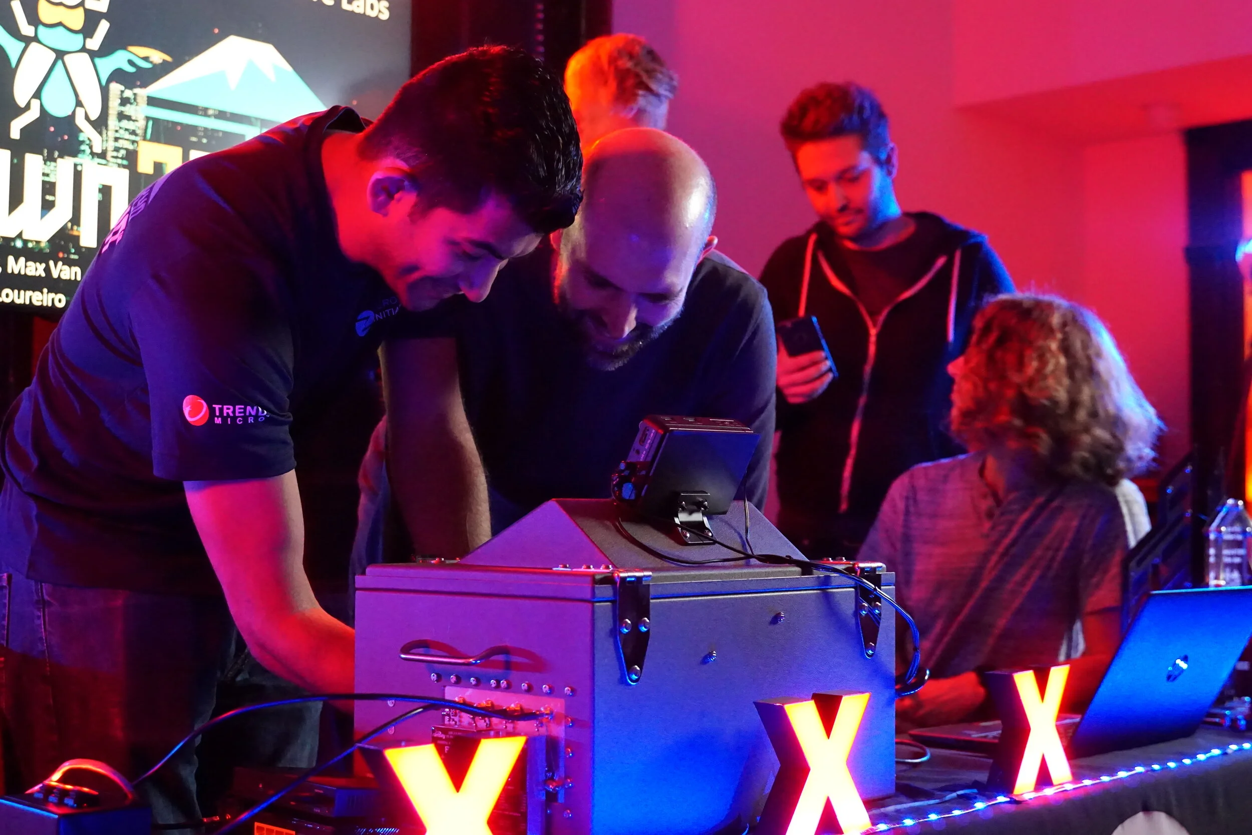 ZDI’s Jasiel Spelman configures a device with Max Van Amerongen of F-Secure Labs