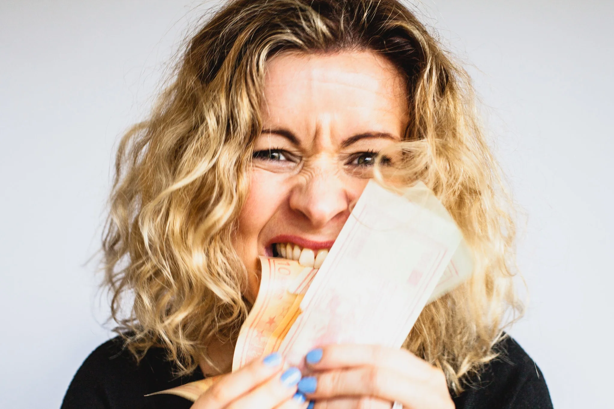 woman holding a few bills