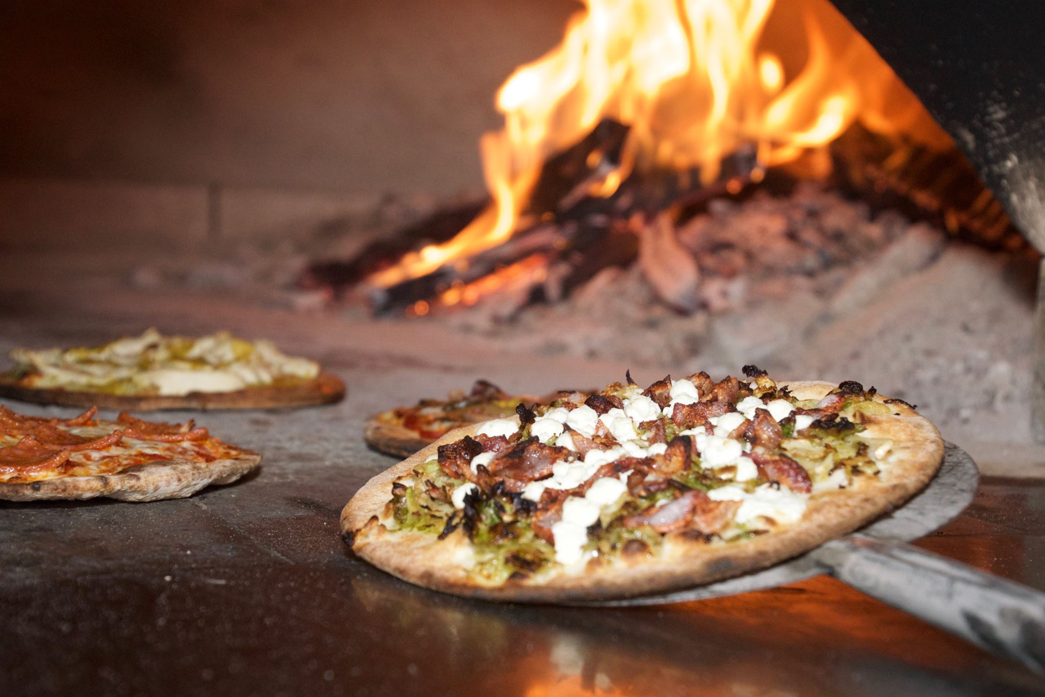 Featuring Brussel Sprout & Bacon, Pepperoni, Green Chili Chicken, and Oven Roasted Veggie