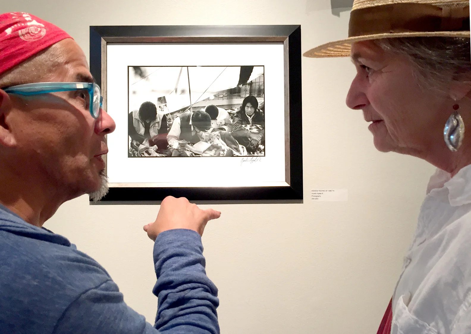 Photographer Aurelio Ayala III discusses his work with gallery associate Janet Cunningham.jpg