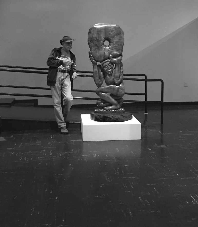 Long-time gallery associate, Stan Schiff looks at a Bill Dilley sculpture