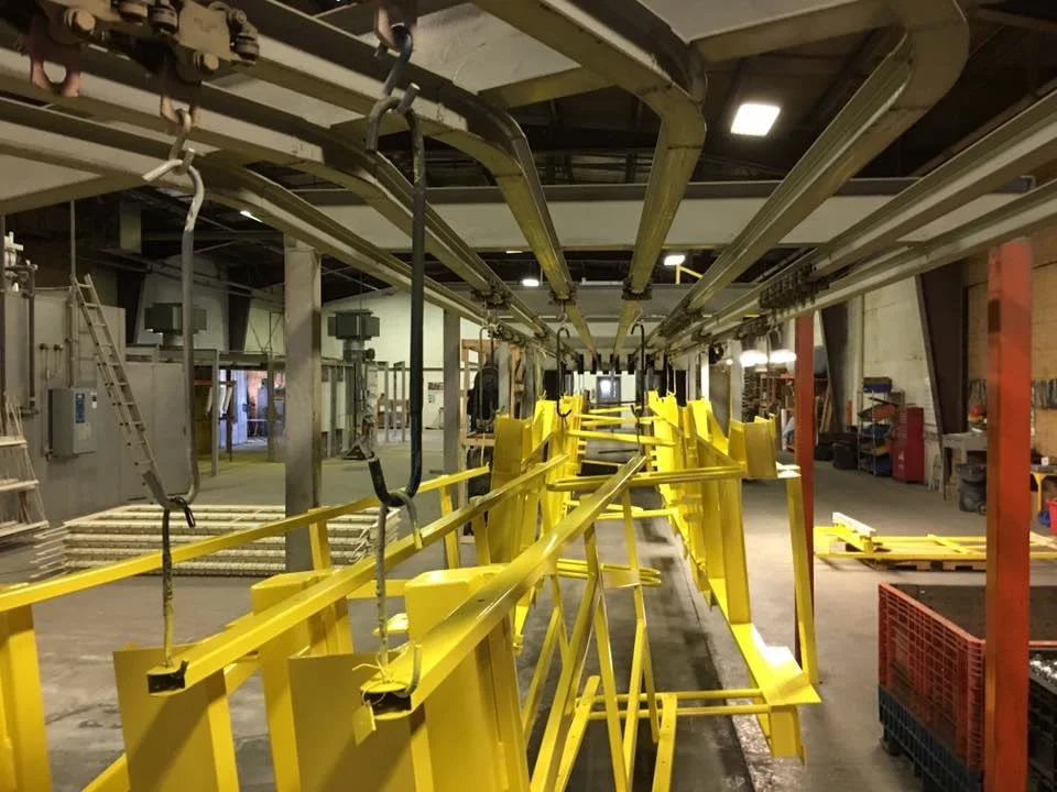 Steel parts moving through the SAFE-T-FAB powder coating line.
