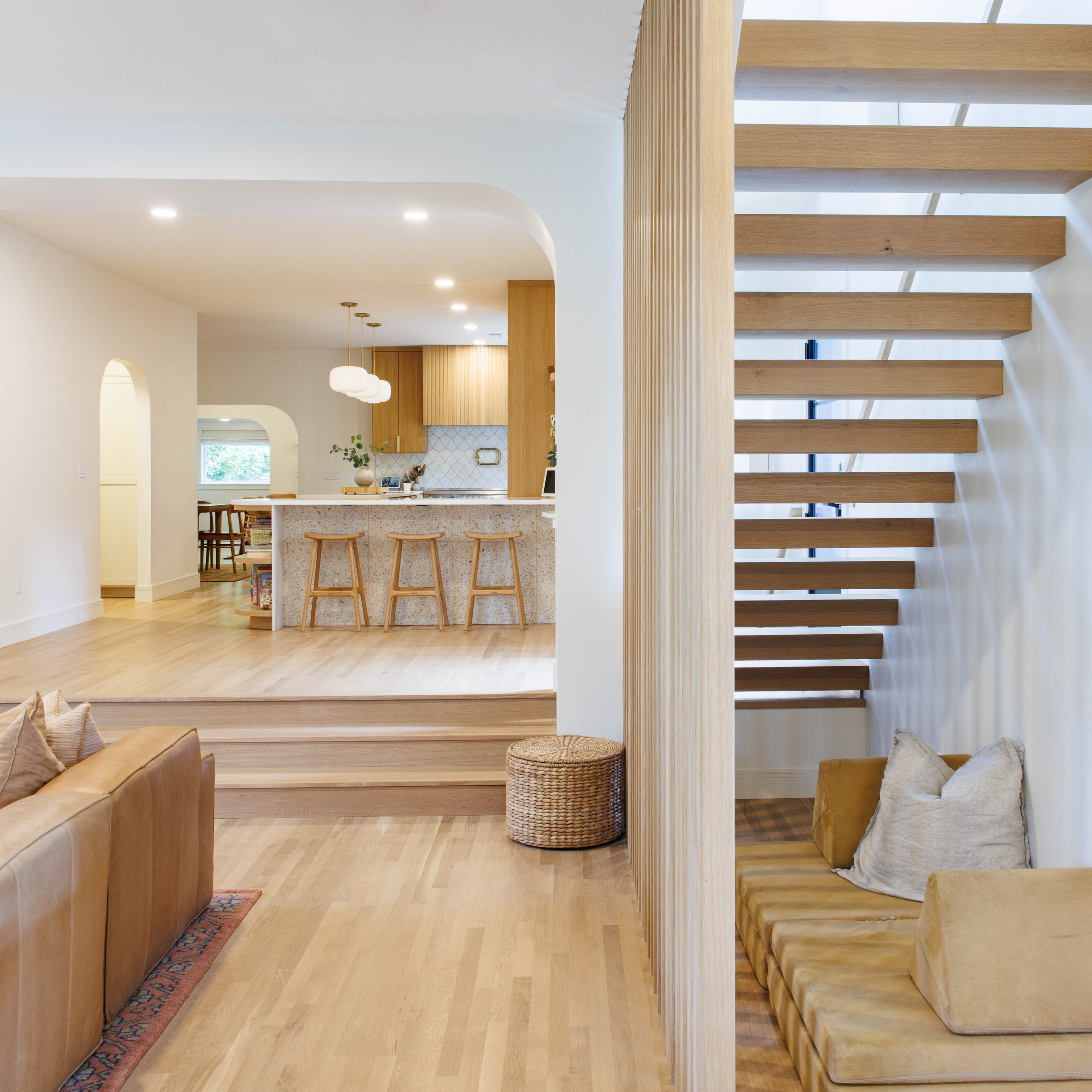 There are so many special details in our clients home. ✨ From the gorgeous oak floors and terrazzo tile peak-a-boo detail to the amazing custom white oak slats that give just enough architectural detail to disguise the stairway but enough visual tran