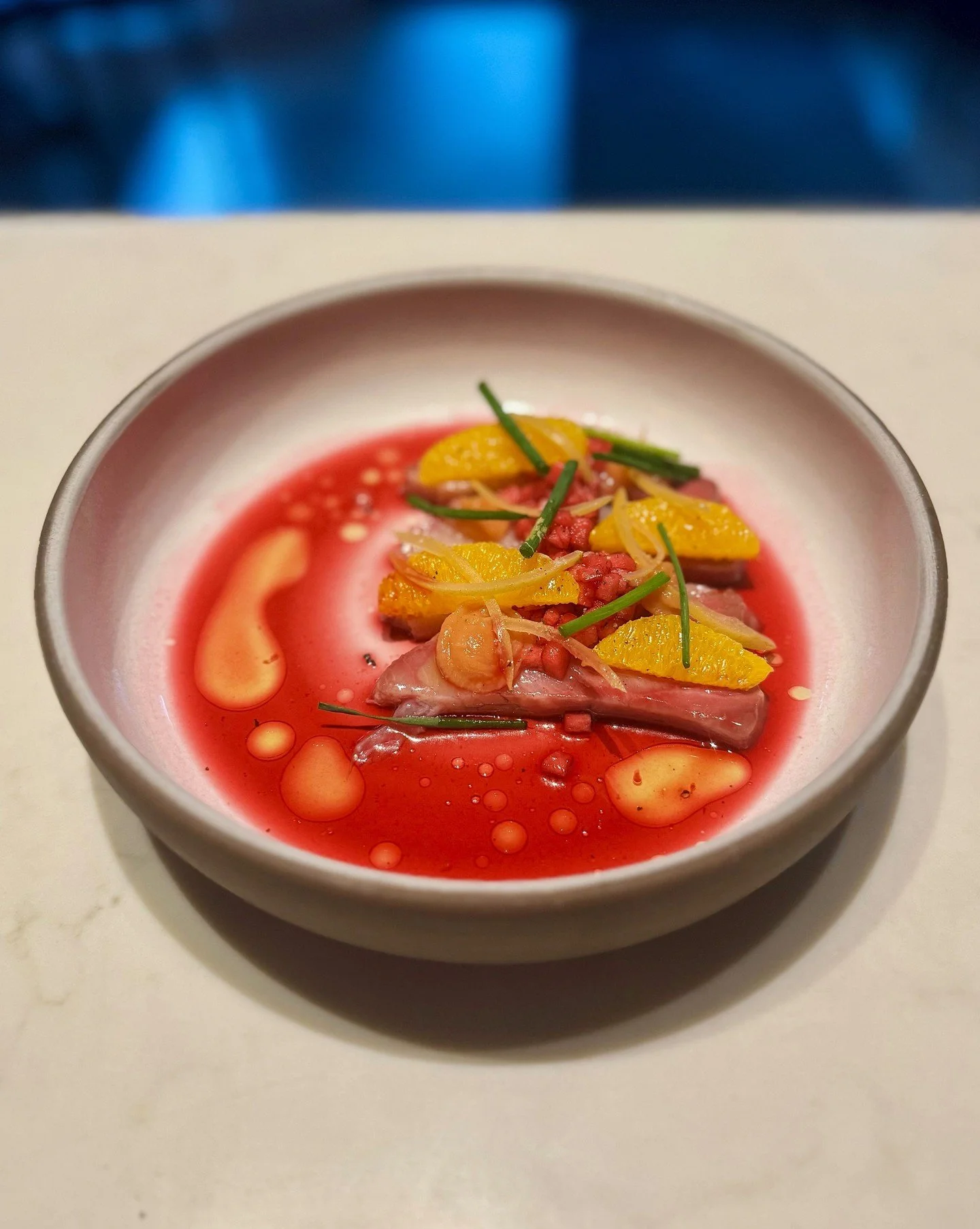 Introducing our Hamachi Crudo. Slices of clean, delicate hamachi paired with hibiscus-pickled Honeycrisp apple and bright orange segments. A drizzle of hibiscus vinegar sharpens the edges; quince fluid gel softens them again. Preserved lemon adds a w