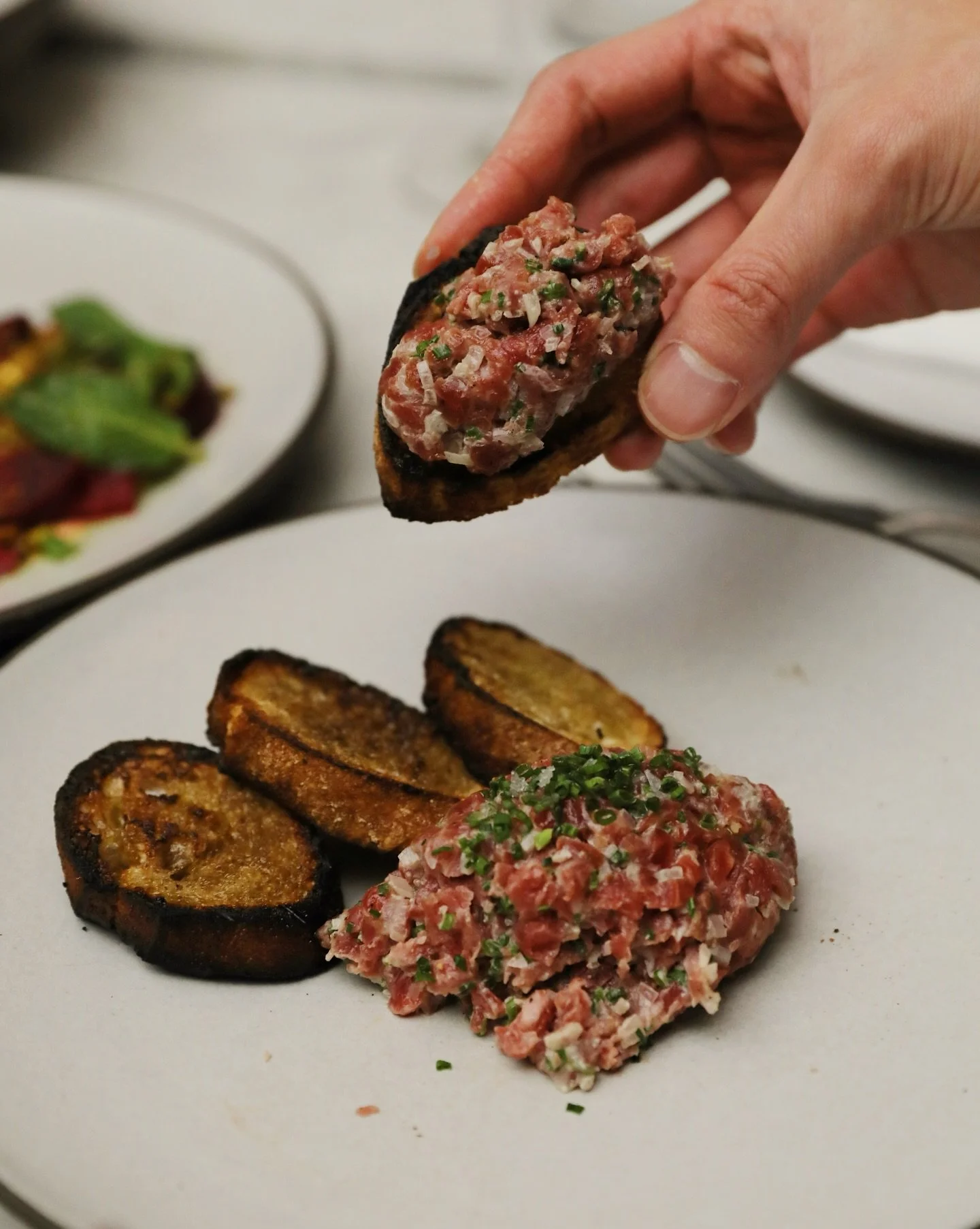Tartare is one of those dishes that leaves no room to hide.

Hand-cut beef. Seasoned just before it leaves the pass. A yolk to emulsify it into it's silky texture.

Crisp crostini. Velvety beef. Fresh herbs for lift.

Our trusted dish to kickoff the 