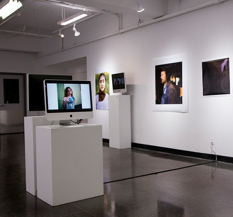  Installation shot from  Gender &amp; The Lens   Monitor: Front monitor: WildFires: Women Photographers Network in Scotland, WHEN THE LIGHT SHIFTS  Background by Ava Cochrane (OCAD U) and Alia Youssef (Ryerson University) 