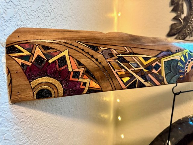 Organic patterns shaped by fire across the mesquite surface of Firelight.