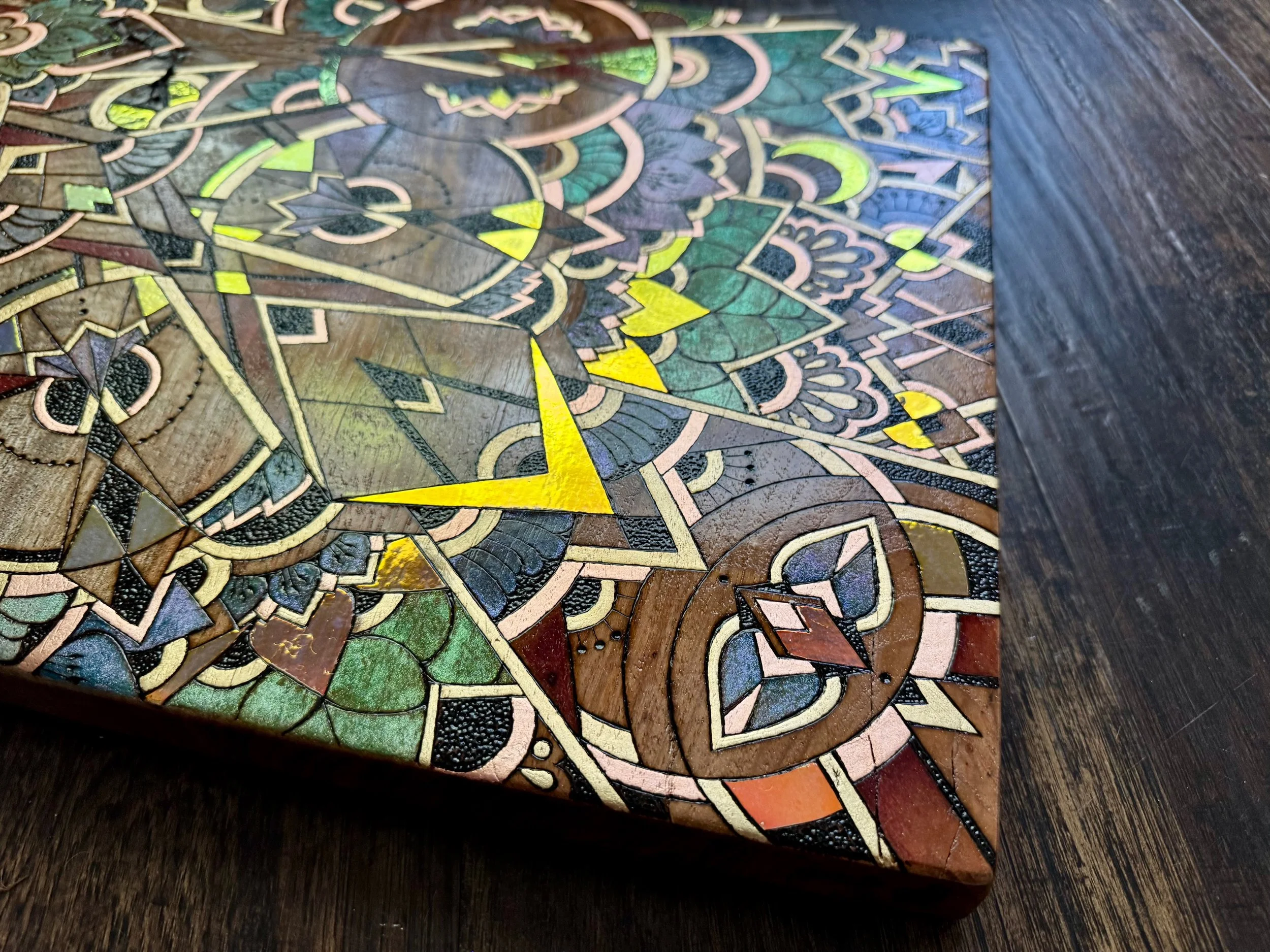 Soft green and gold botanical elements with layered sacred geometry, handmade in Austin.