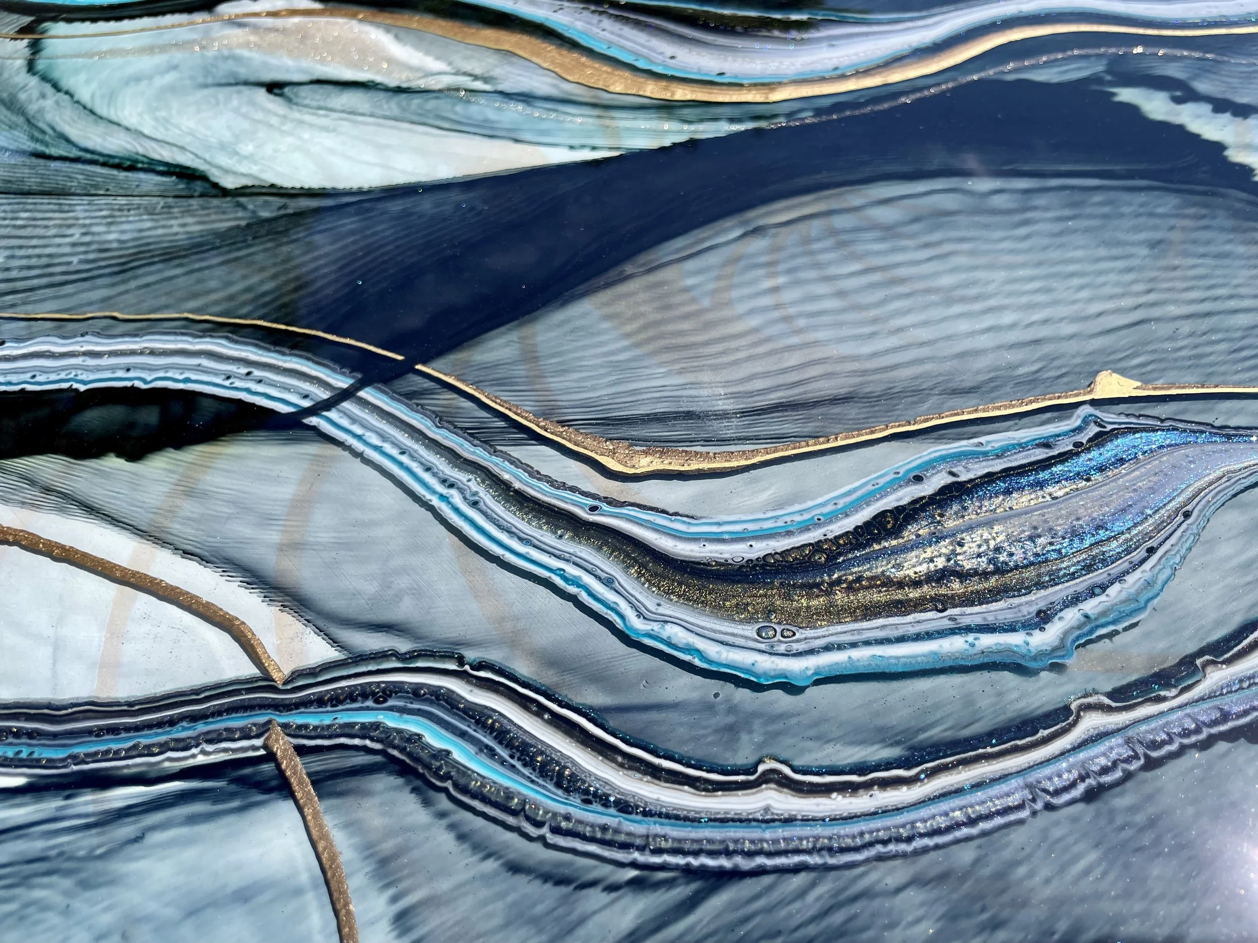 Flowing wall art created with alcohol ink and resin