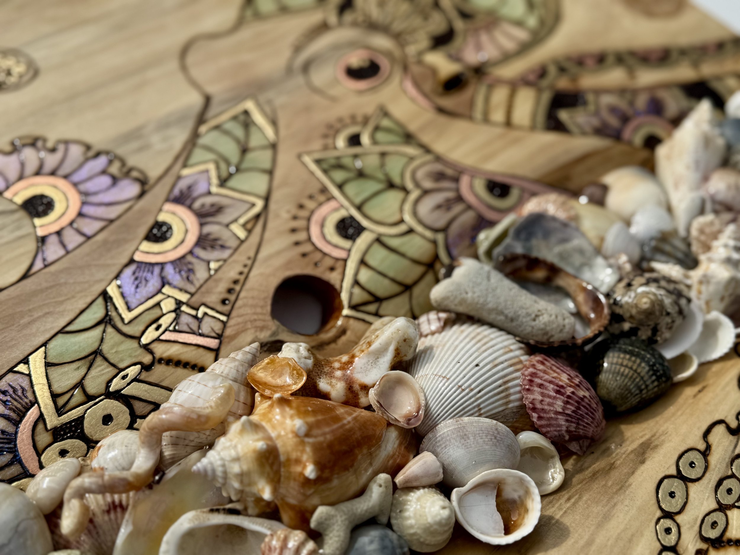 Mixed media wall art with shells, resin, and alcohol ink