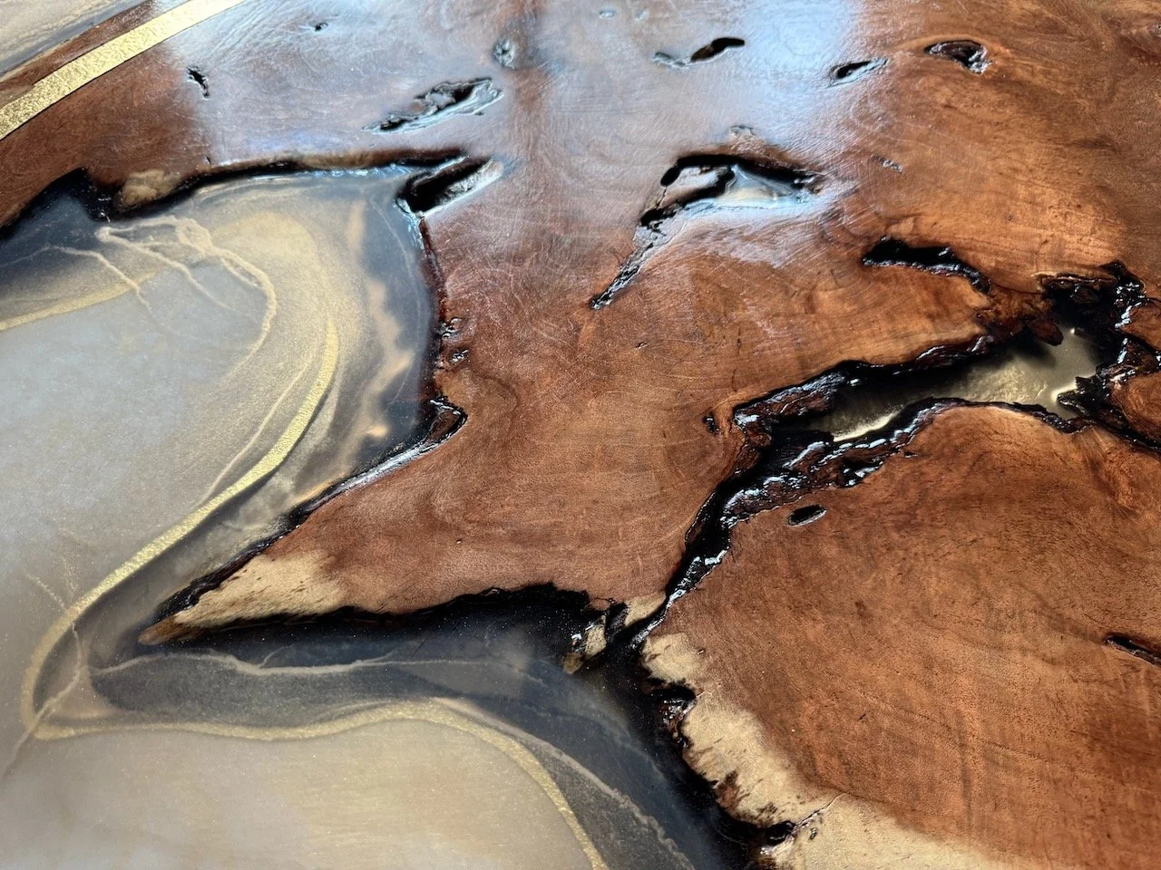 A glowing wood and resin composition with harmonized tones of gold, bronze, and warm light.