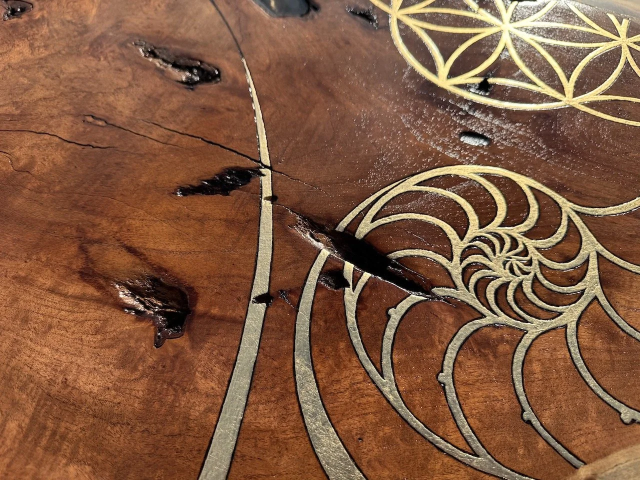 Golden resin and wood grain blending together in rhythmic harmony, part of Anne Shackelford’s Islands in the Sun collection.