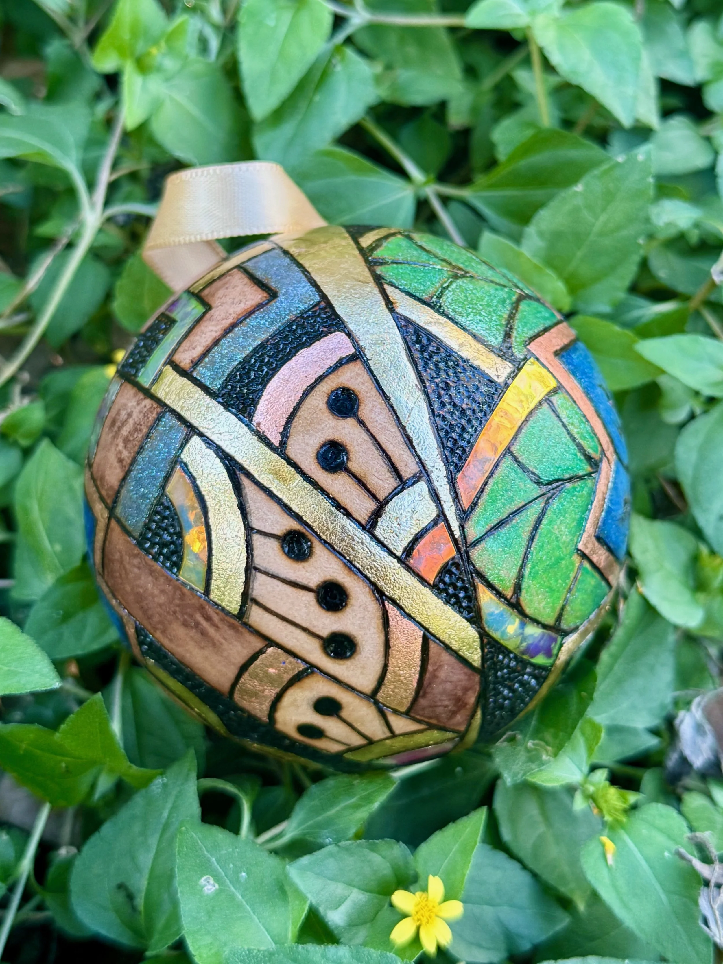 Collectible ornament from the Firelight Collection, blending gilding, pigment, and organic design.