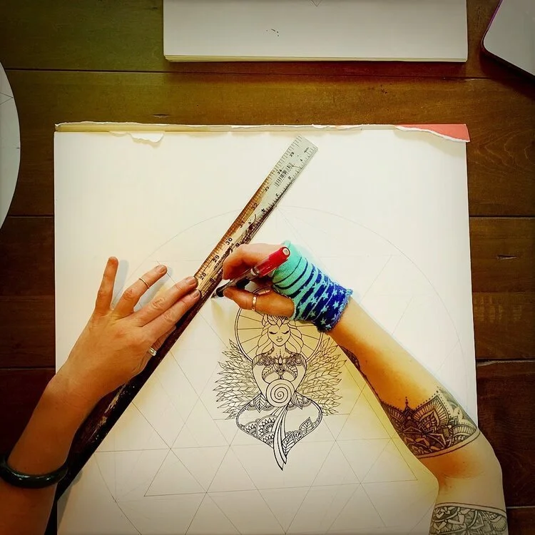  A behind-the-scenes look at Anne Shackelford sketching her 2019 Christmas angel. This is an annual tradition that mirrors her evolving inner world and artistic exploration. This year's design, anchored in sacred geometry, ink detail, and symbolism, 