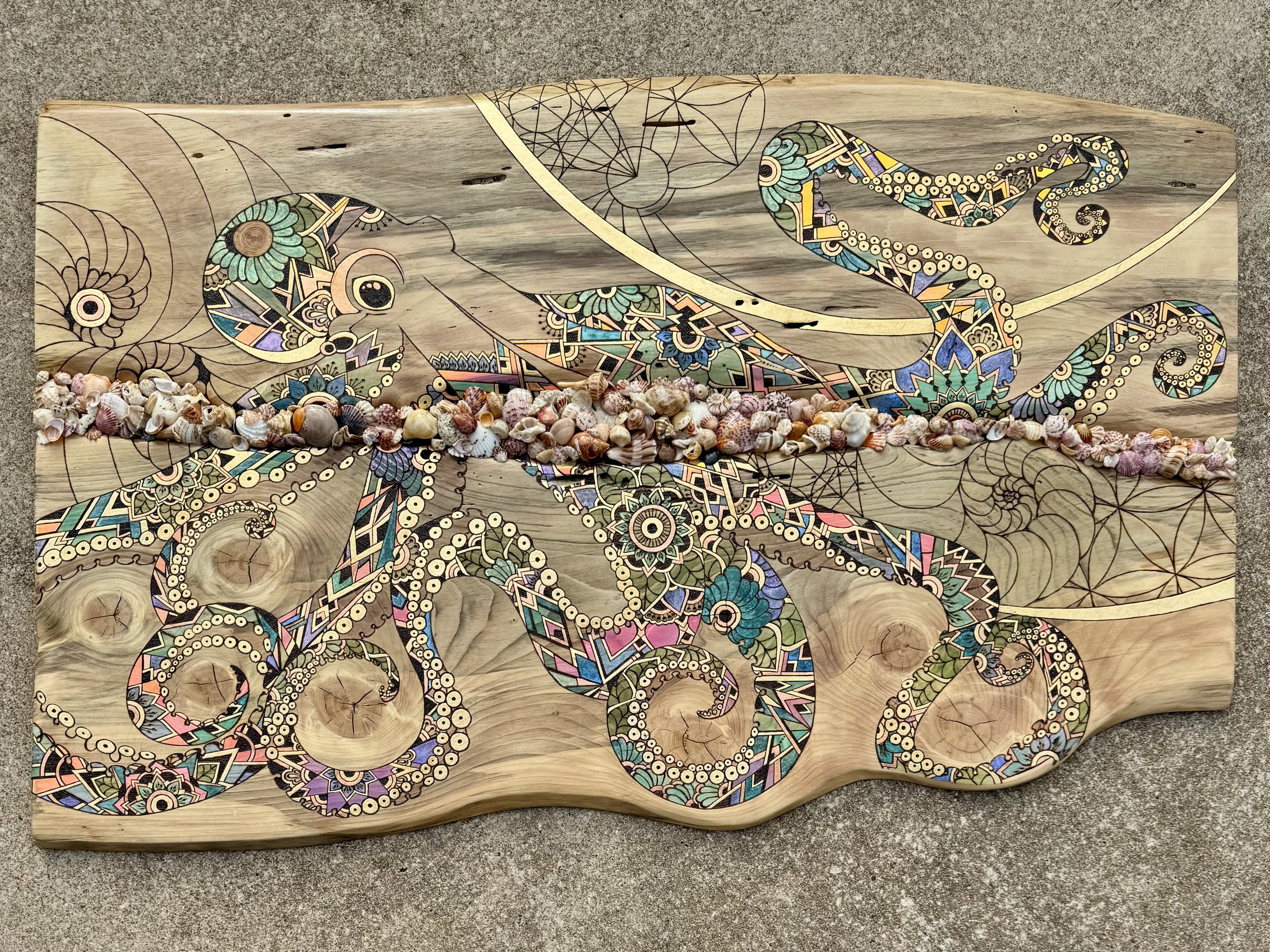  All Singing, All Dancing, also known as Cassandra, is Anne Shackelford’s largest wall art piece to date. The 2025 work features an octopus design layered with alcohol inks, gold and copper leaf, glitter, and holographic film that shimmers like stain