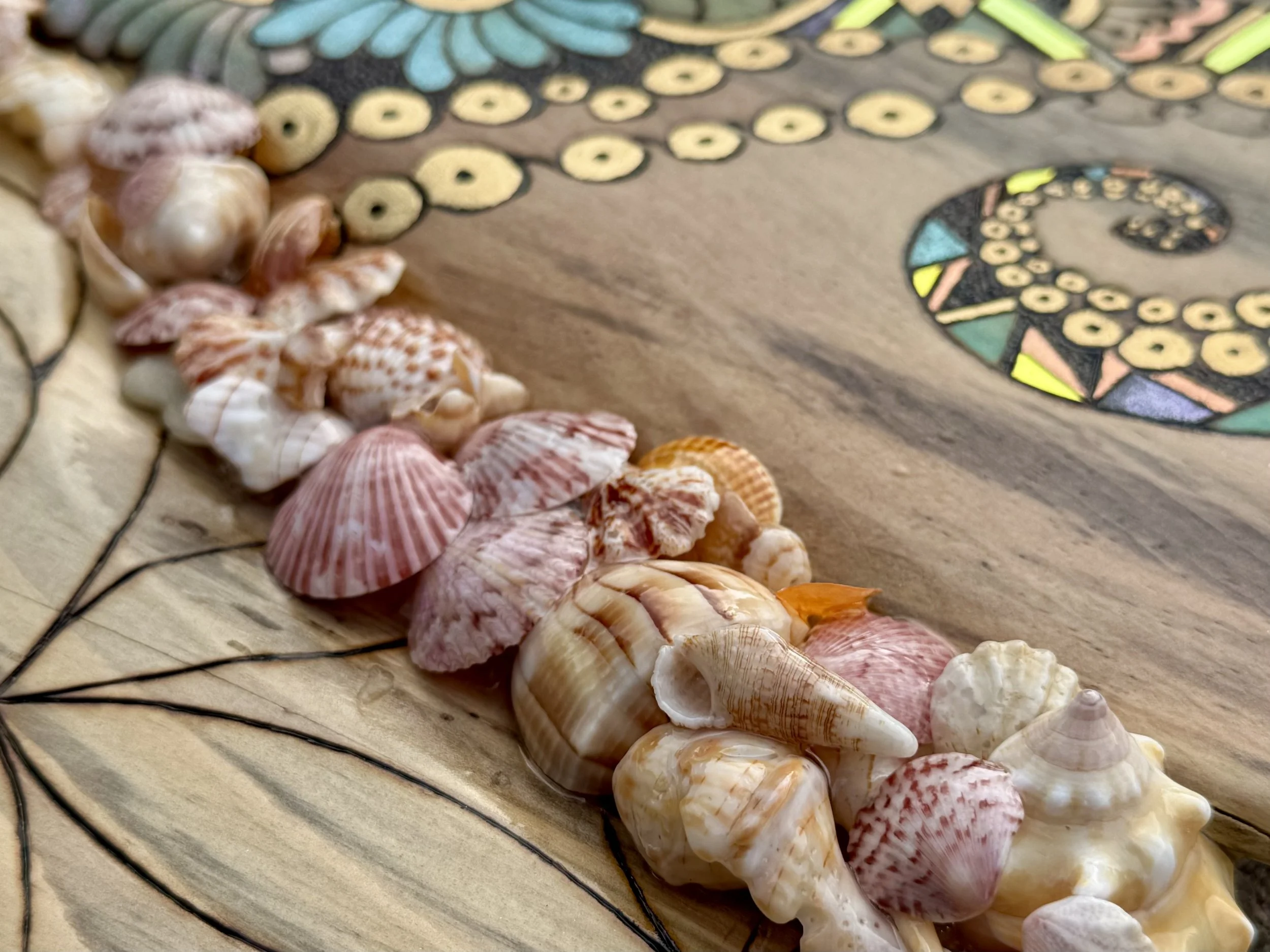 Glossy holographic elements give depth and shimmer to this mixed media pyrography wall piece.