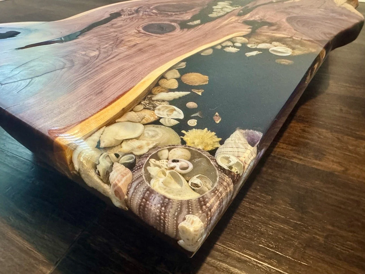 Detail view of embedded shells within Grace, a functional art table.