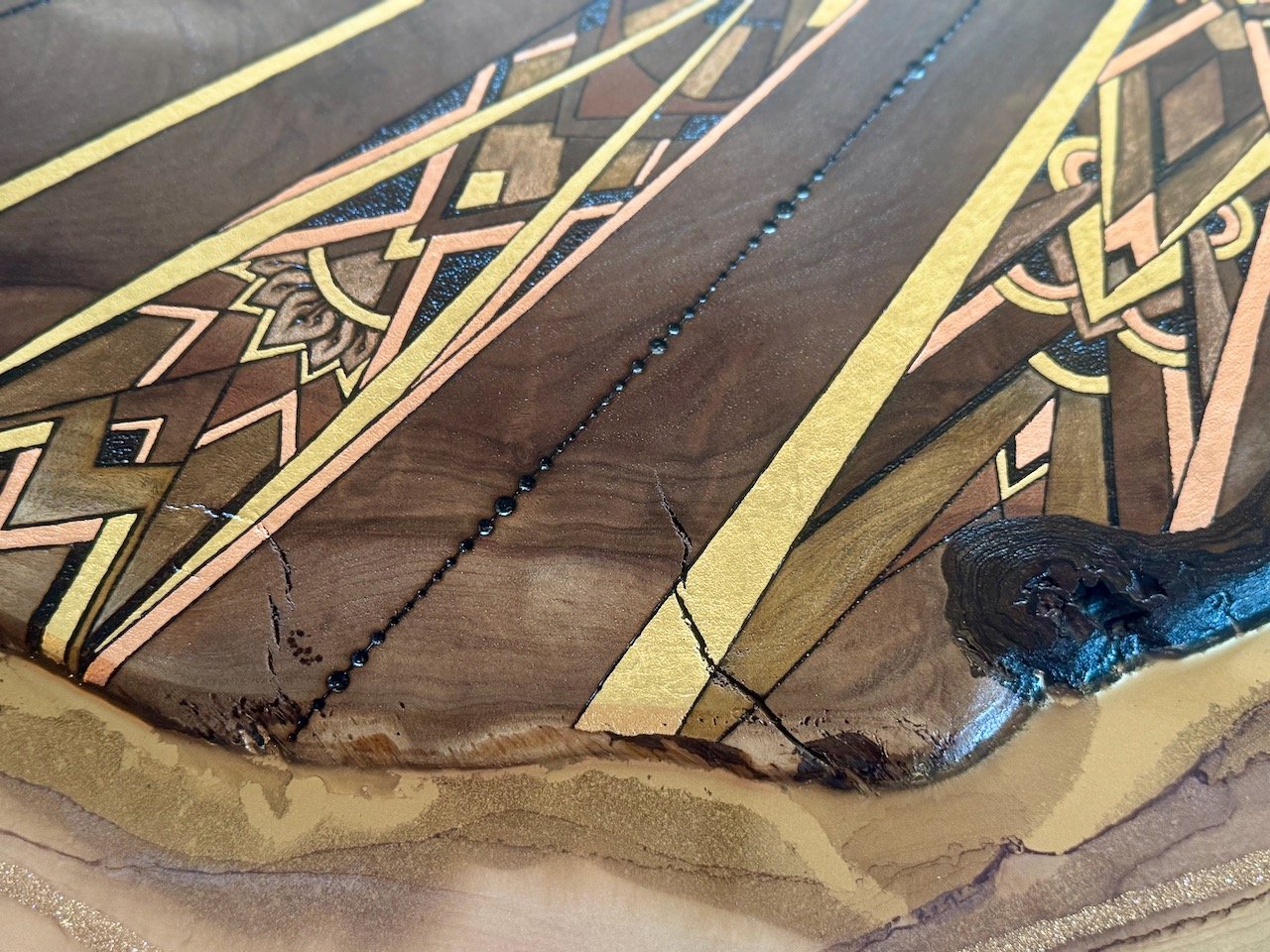 Wall art featuring a sun and shining rays, crafted from resin and walnut.