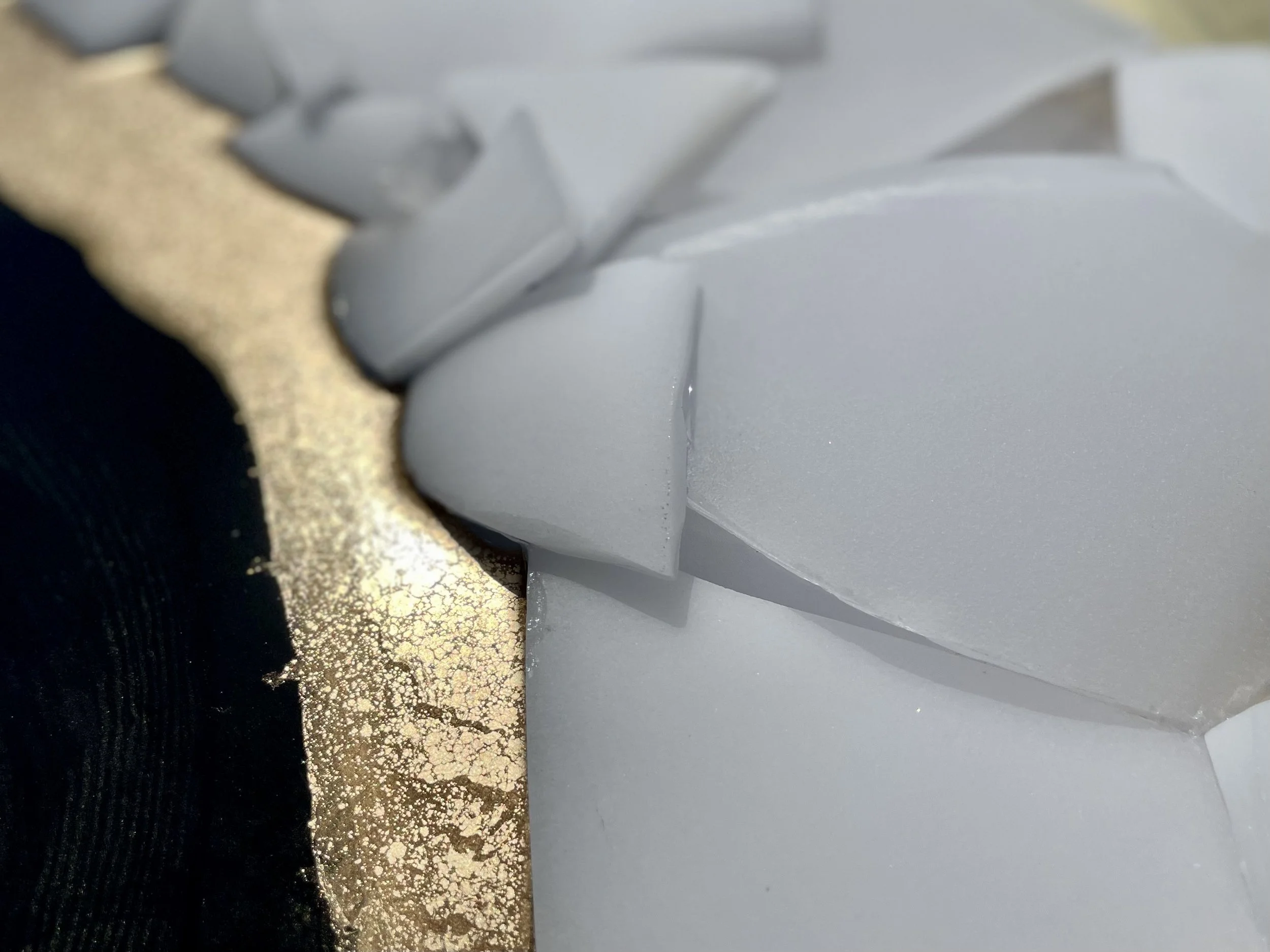 Repurposed crystal glass wall art woven into layered resin surface