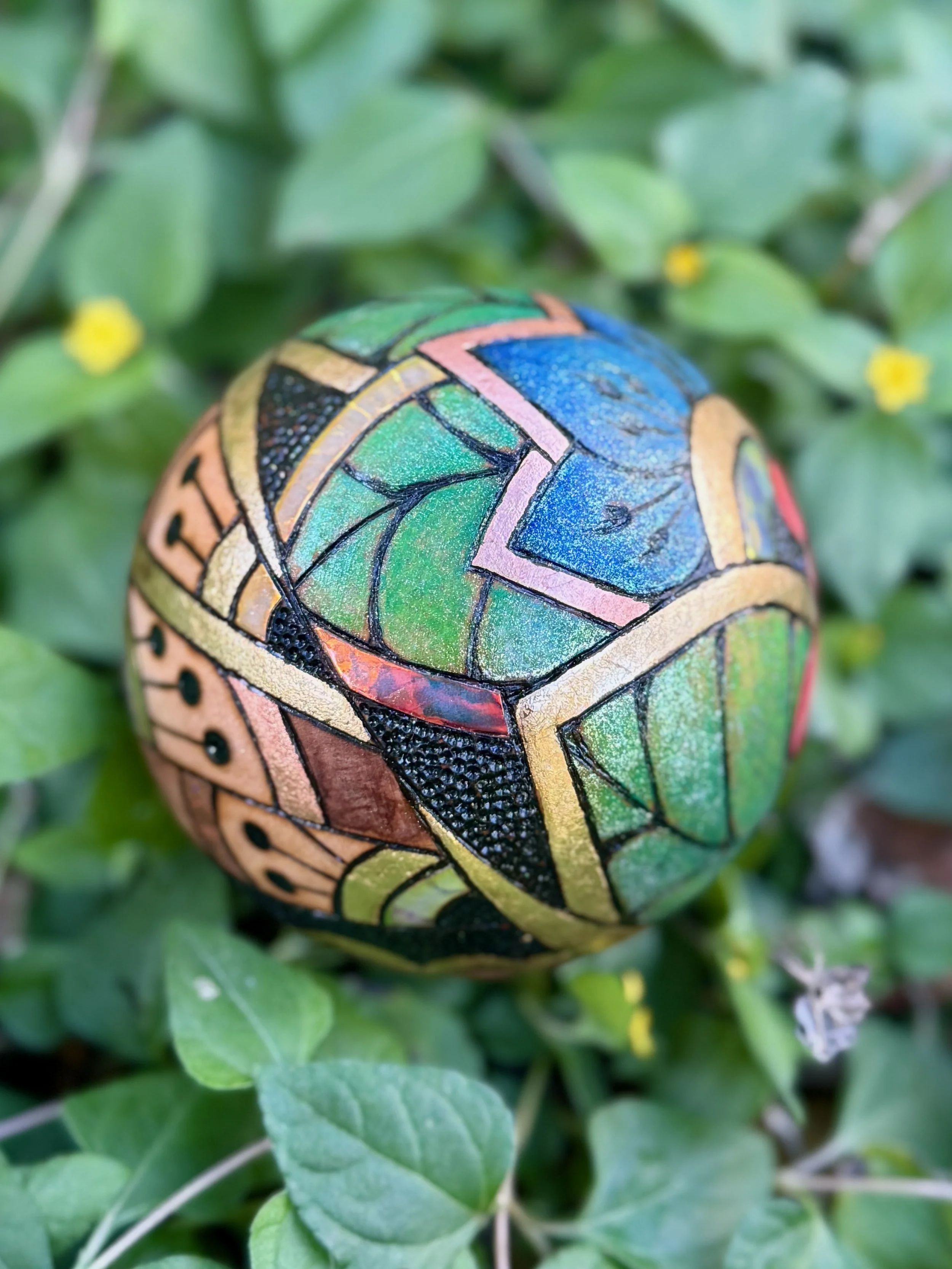 Reflective art sphere by Austin artist Anne Shackelford, blending pigment, gilding, and resin light.