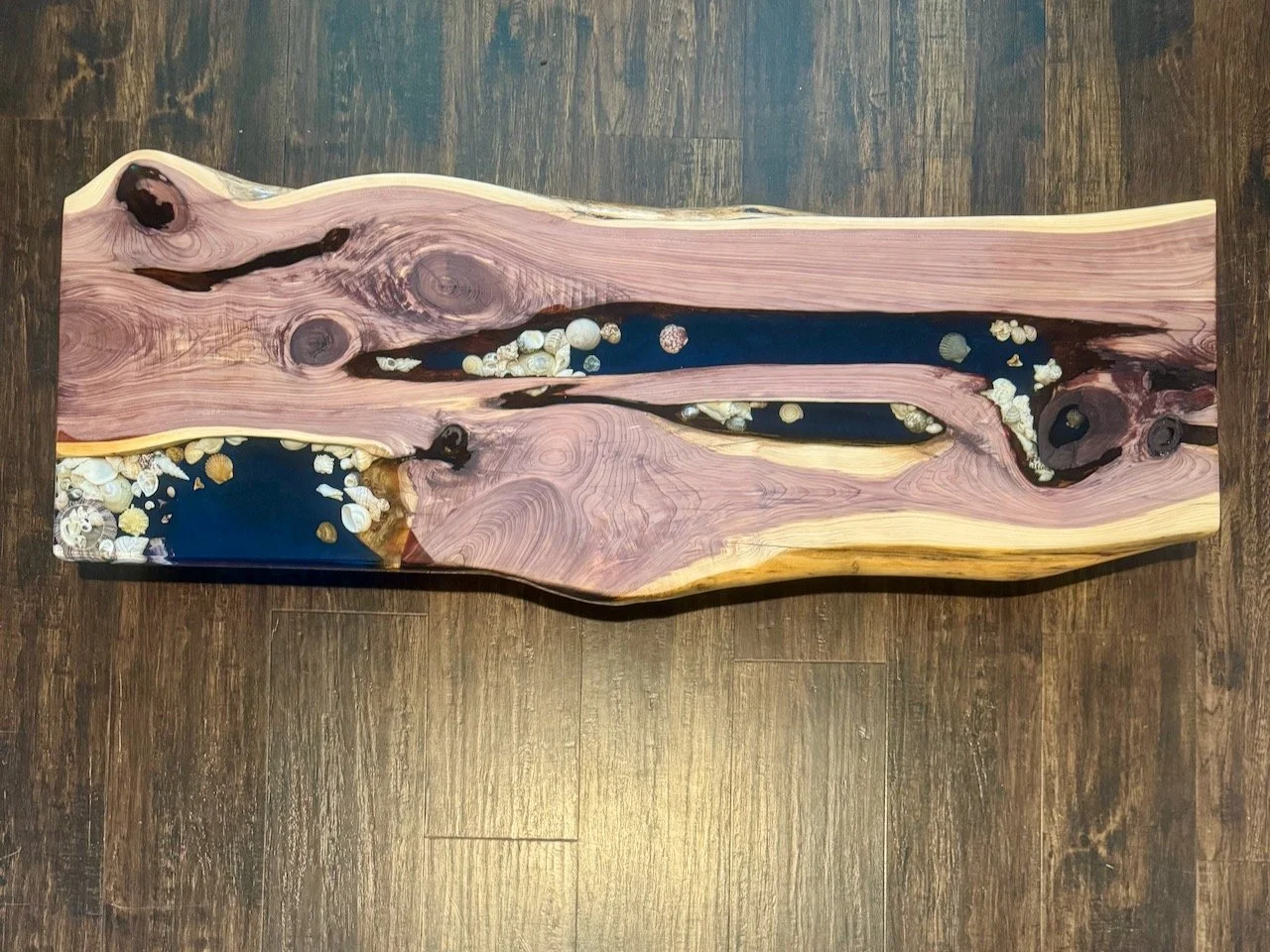 Grace table top showing Texas Juniper wood grain and shimmering resin.