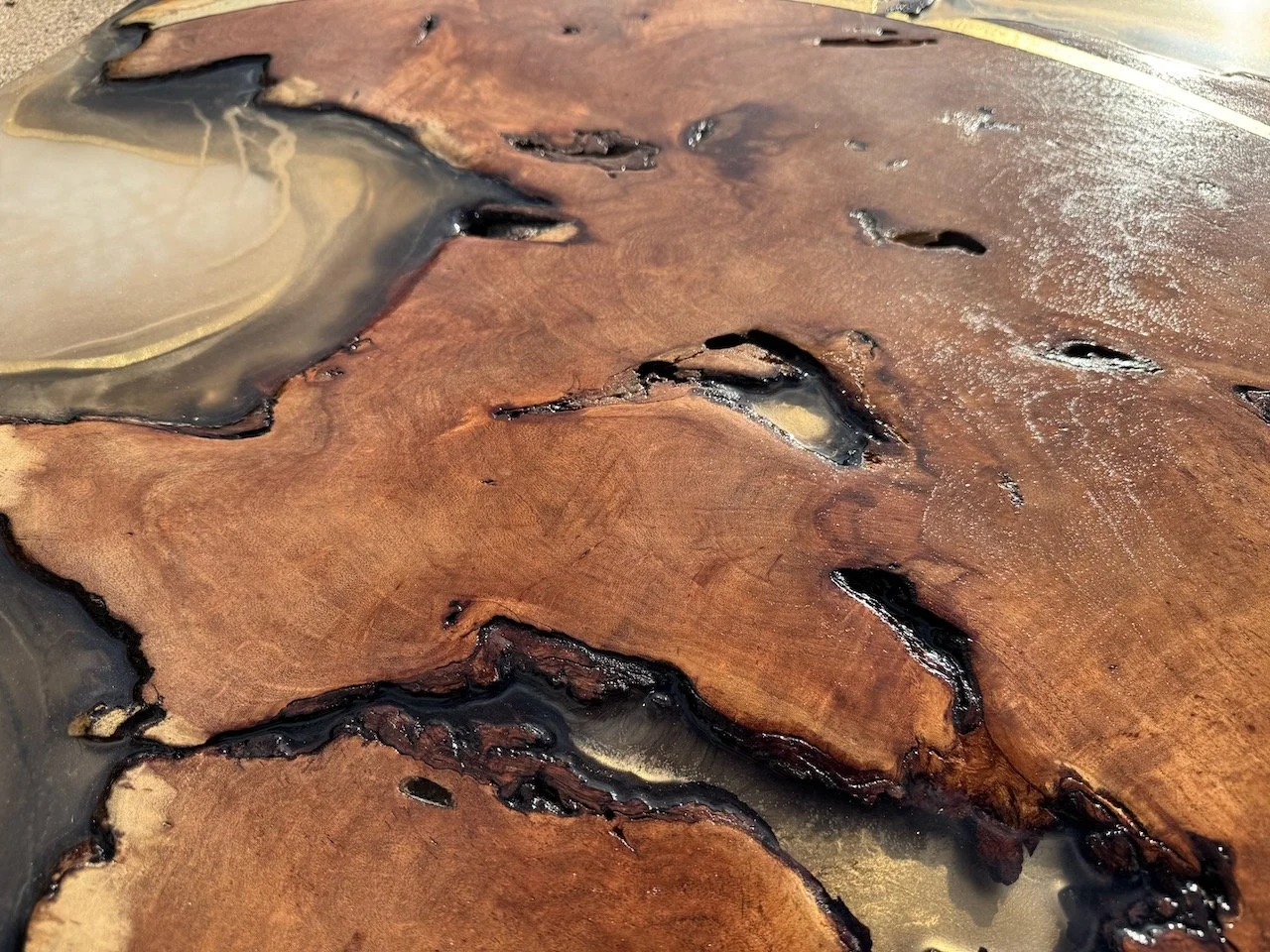 Close view of pyrography details within Islands in the Sun, showing the warmth of fire-etched lines balanced with glossy resin depth.