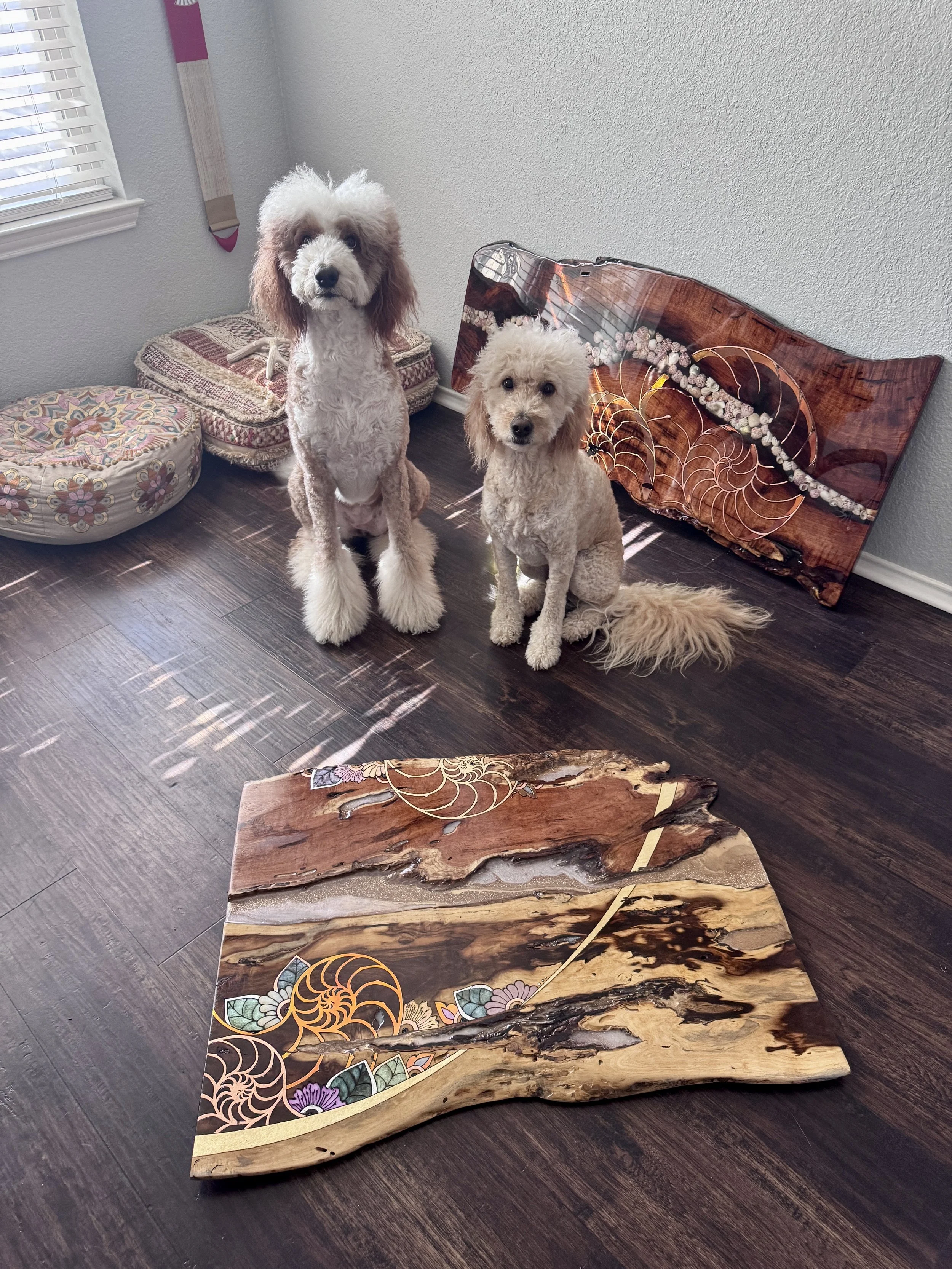 Anne Shackelford’s studio dogs sitting behind the completed wood artwork, showing the scale of the original piece.