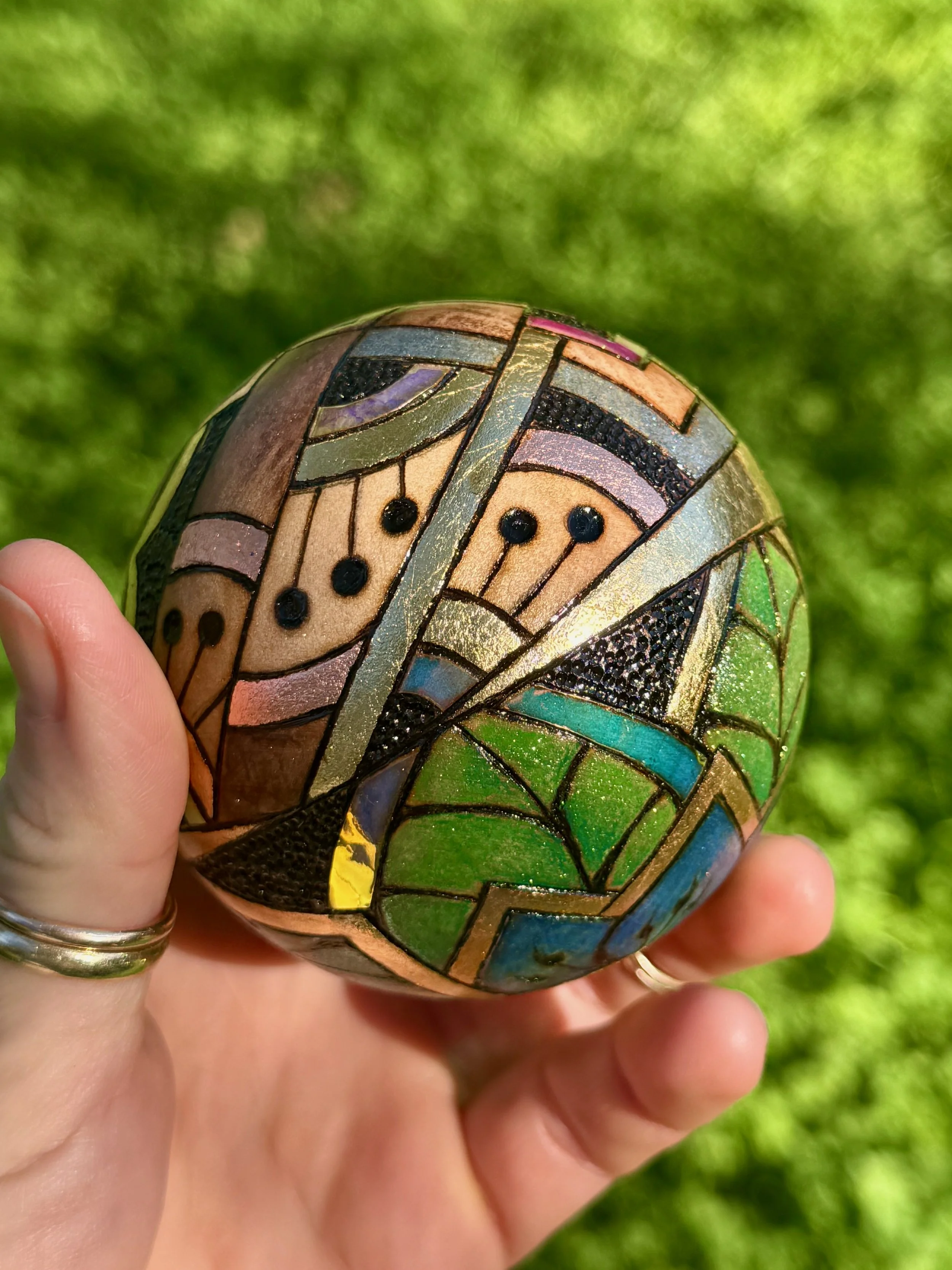 Nature-inspired ornament from the Firelight Collection, created with pigment, gilding, and radiant light.