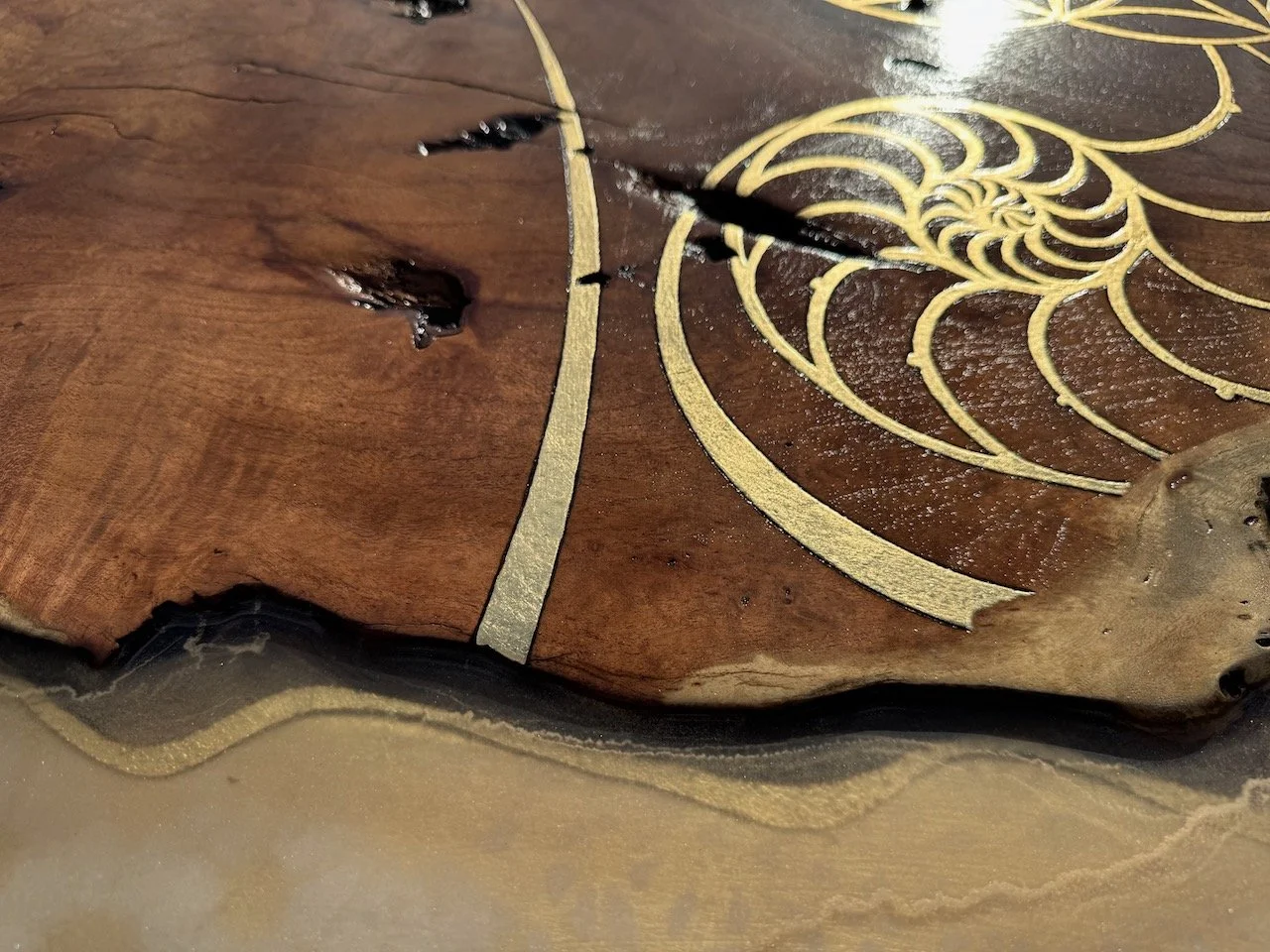 The surface of Islands in the Sun appears to flow like water meeting land, illuminated by gold tones and fine pyrography.