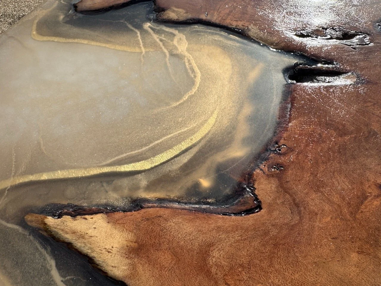 Textured resin and metal leaf pattern catching light across the surface of Anne Shackelford’s Islands in the Sun.