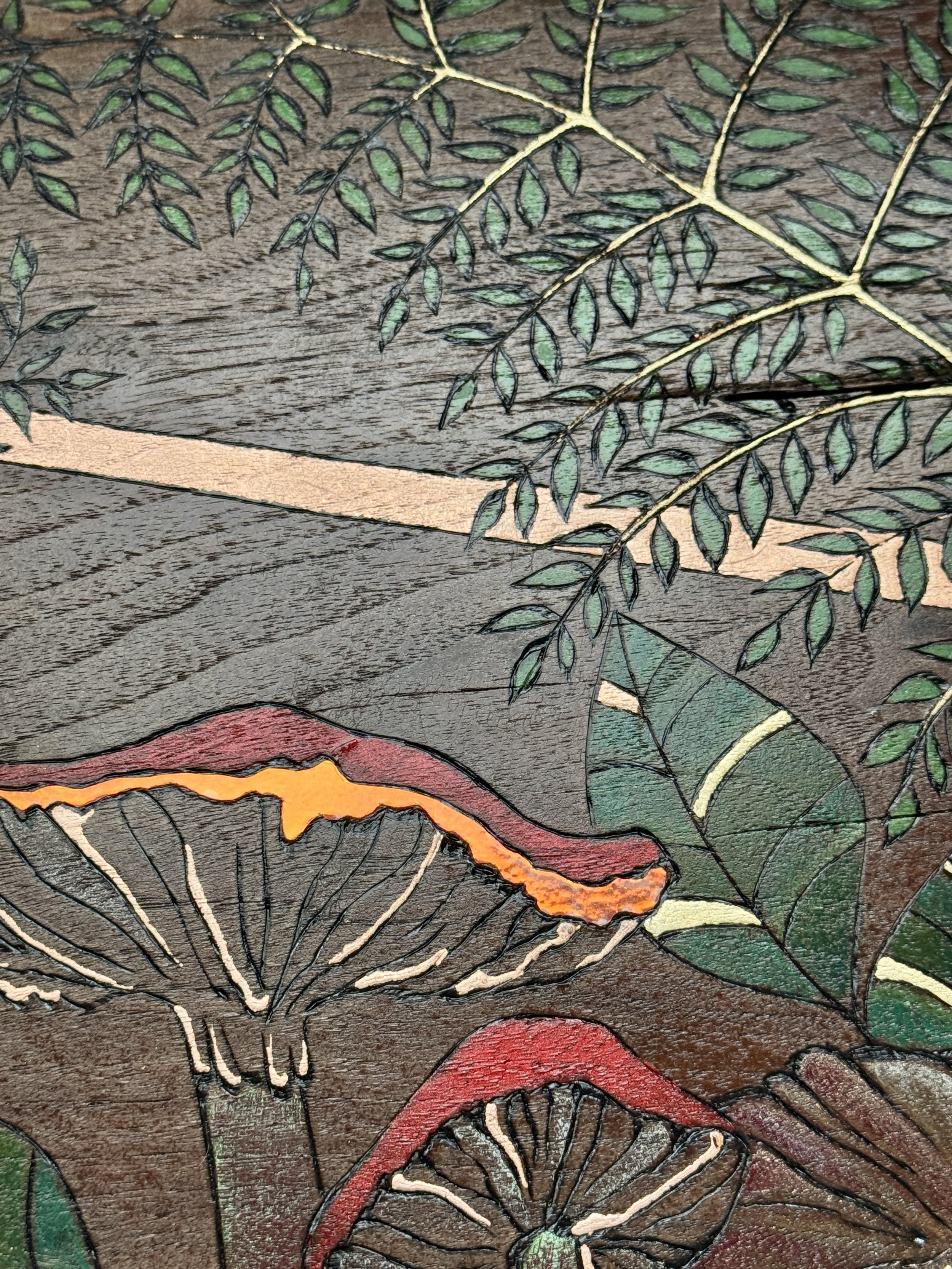 Botanical wall art featuring ferns, mushrooms, and snail in mixed media wood piece