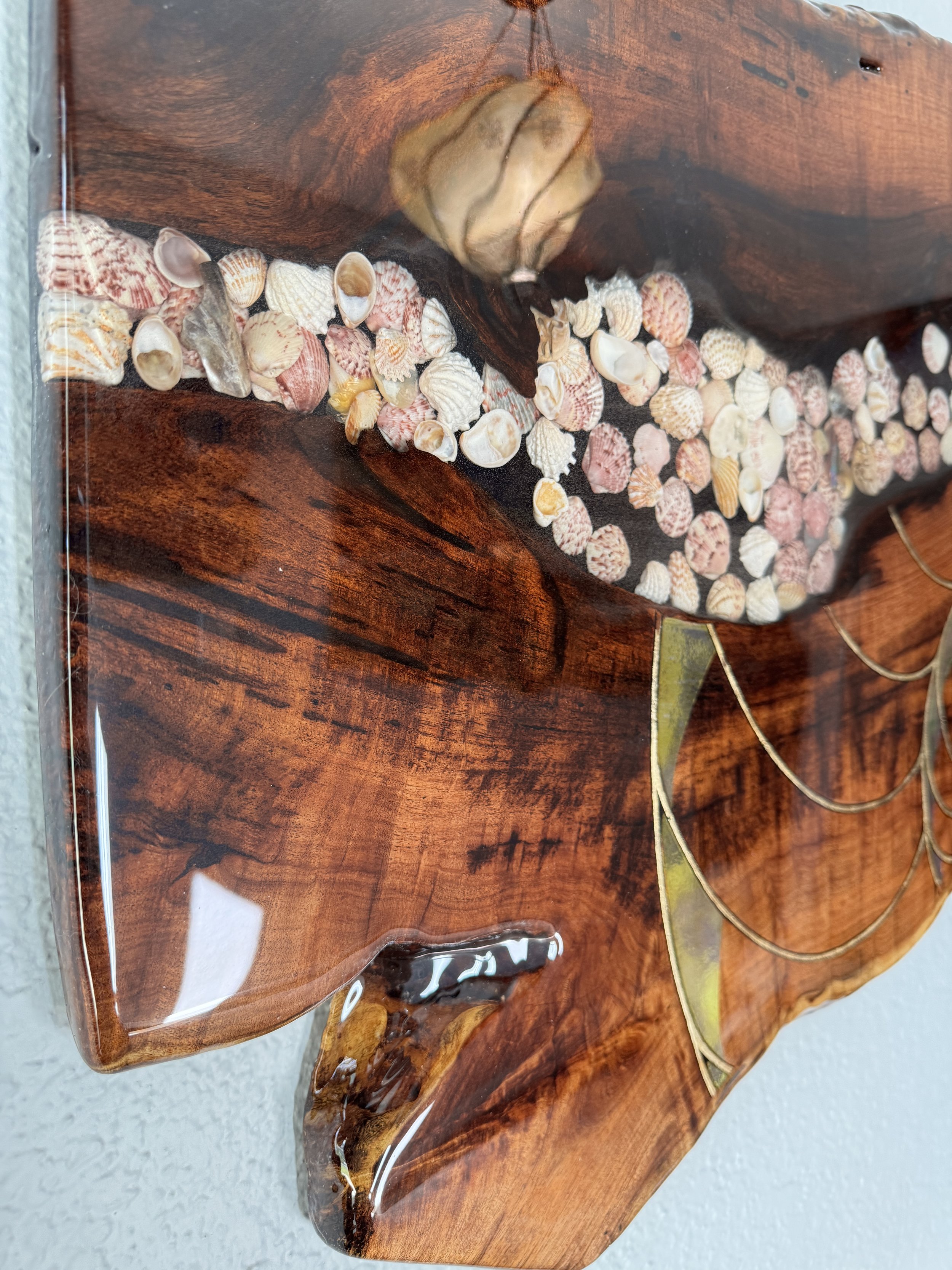 Functional art piece combining wood shells and metal leaf