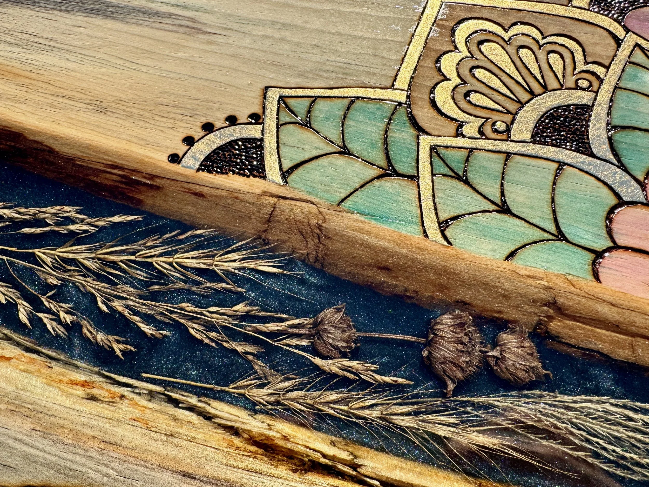 Beloved floral and grass wall art by Anne Shackelford, combining pyrography and resin.