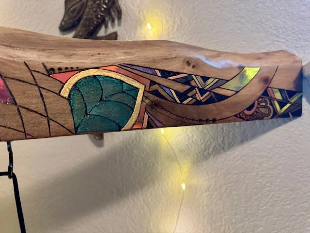Detail view of Firelight showing warm wood grain and burned linework.