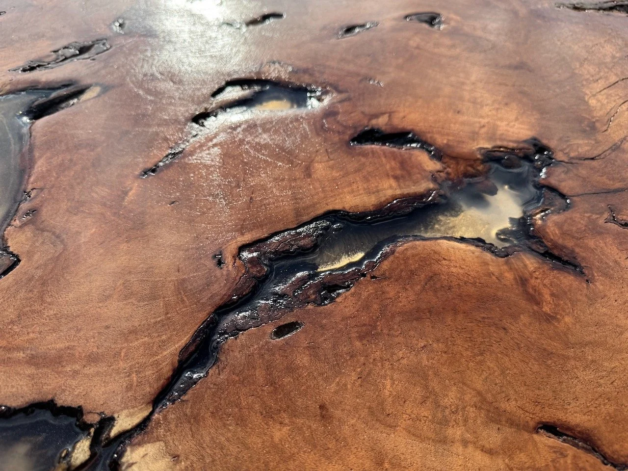 Anne Shackelford’s mixed media wall artwork blending resin, wood, and shimmer pigment to evoke natural sunlight.