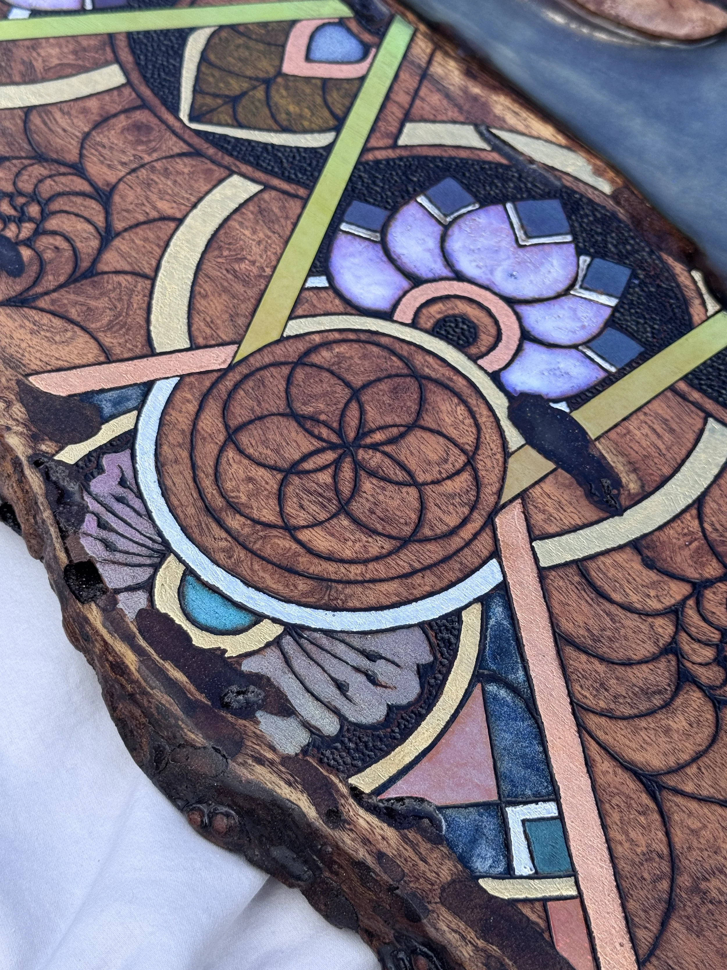 Close-up detail of Alchemy of Becoming highlighting geometric design, color, and mixed media layers.